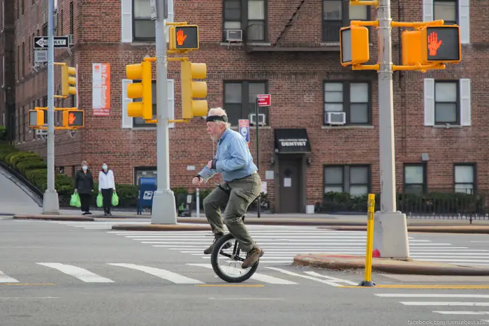 A photo of a man on a unicycle in NYC